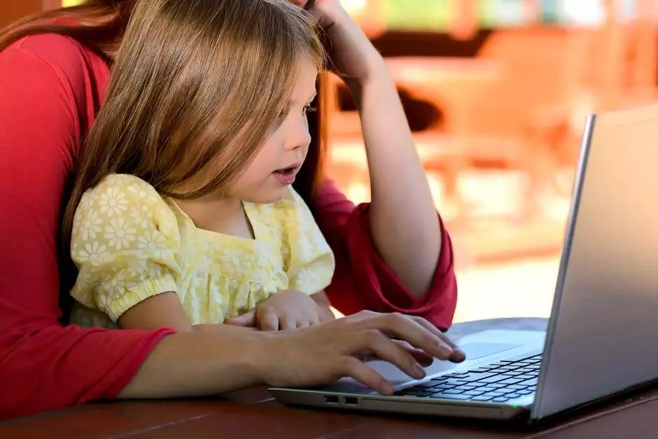 child and parent on a computer