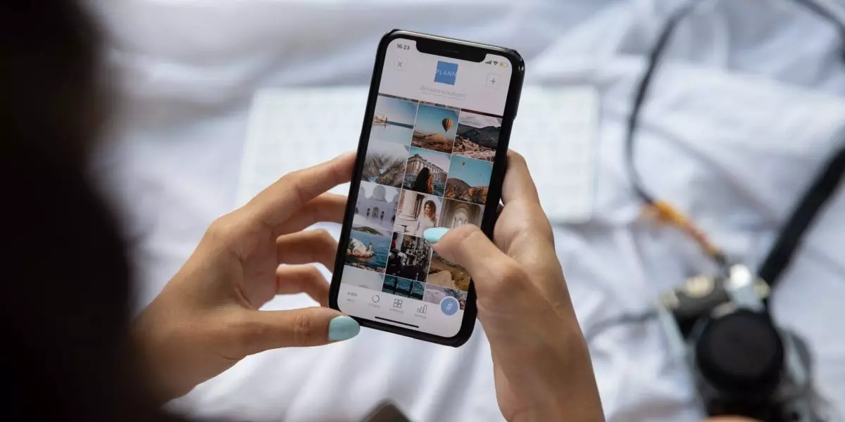A person scrolls through photos on a phone.